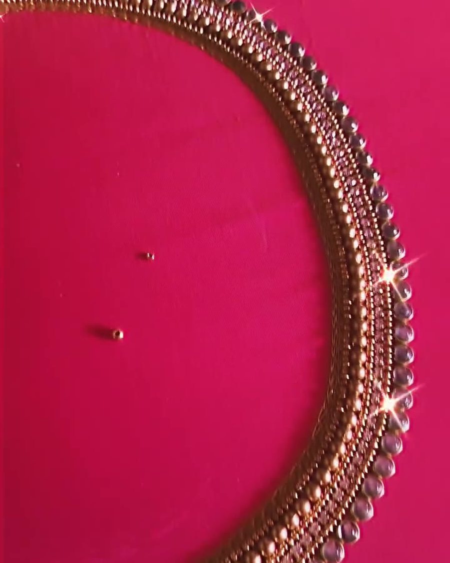 Pink silk blouse with pearl and gold bead U-neckline aari work in progress on the frame